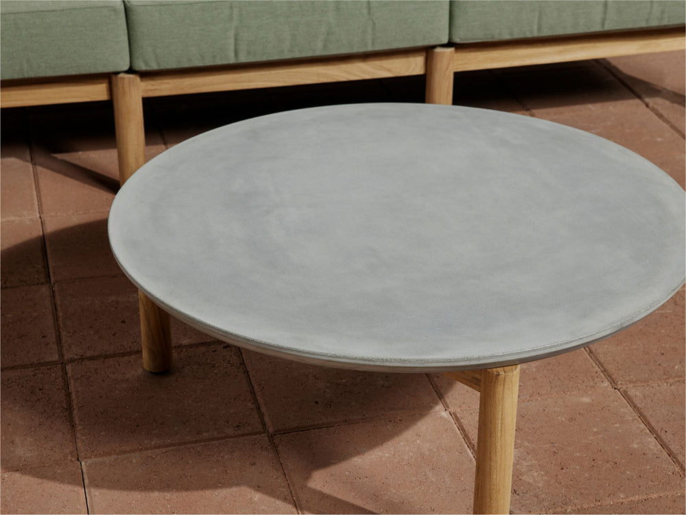 A Neighbor concrete coffee table on a sunny patio