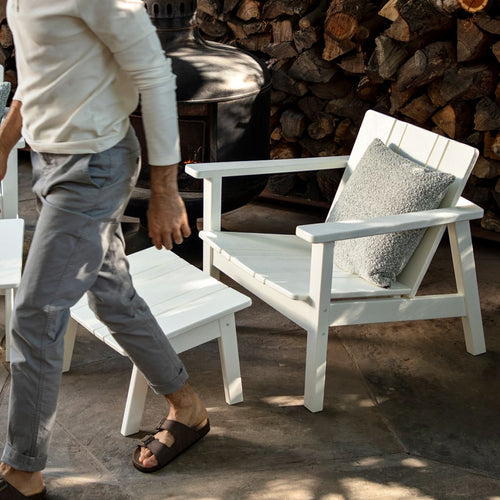 A studio photo of Low Chair Black / Chair + Ottoman