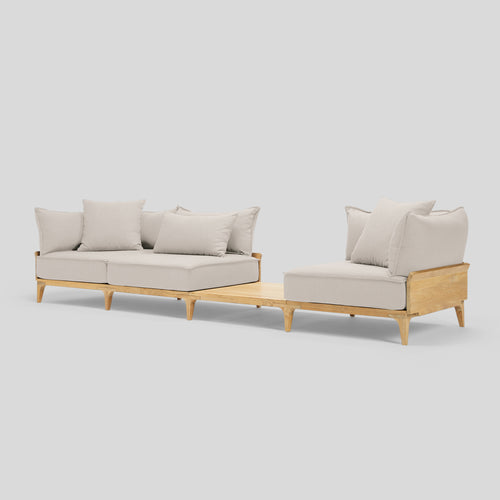 A studio photo of Bluff Sofa with In-line Table Sunbrella Parchment